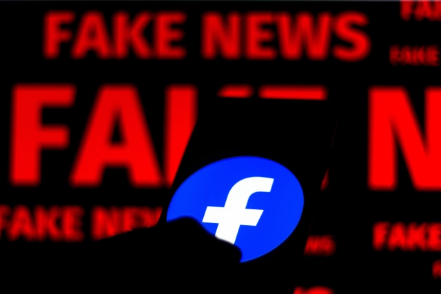 BRAZIL - 2020/06/15: In this photo illustration the Facebook logo is displayed on a smartphone and a red alerting word "FAKE NEWS" on the blurred background. (Photo Illustration by Rafael Henrique/SOPA Images/LightRocket via Getty Images)