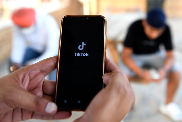 Indian mobile users browses through the Chinese owned video-sharing 'Tik Tok' app on a smartphones in Amritsar on June 30, 2020. - TikTok on June 30 denied sharing information on Indian users with the Chinese government, after New Delhi banned the wildly popular app citing national security and privacy concerns.
"TikTok continues to comply with all data privacy and security requirements under Indian law and have not shared any information of our users in India with any foreign government, including the Chinese Government," said the company, which is owned by China's ByteDance. (Photo by NARINDER NANU / AFP) (Photo by NARINDER NANU/AFP via Getty Images)