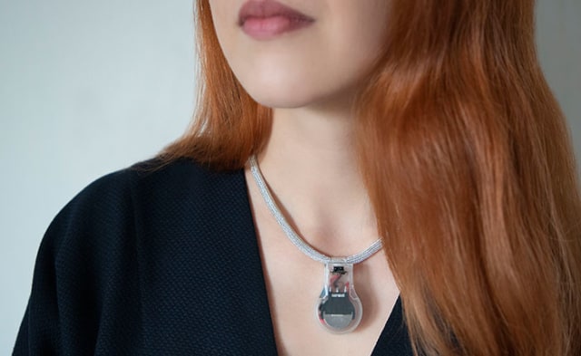 A woman wearing NASA's Pulse necklace