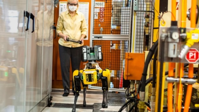 Paula Wiebelhaus, Fluffy’s handler, navigates Fluffy, the dog-like robot through tough-to-reach areas within the plant. Ford is tapping four-legged robots at its Van Dyke Transmission Plant in early August to laser scan the plant, helping engineers update the original computer-aided design.