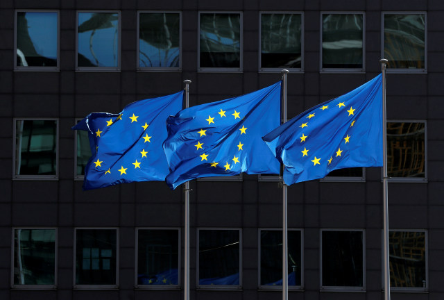 European Union flags flutter outside the European Commission headquarters in Brussels, Belgium August 21, 2020. REUTERS/Yves Herman