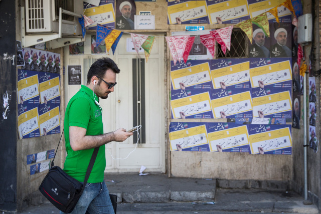 A guy uses his smartphone to check out election news in Tehran, Iran might 17, 2017. REUTERS/TIMA ATTENTION EDITORS - THIS IMAGE WAS SUPPLIED BY AN AUTHORIZED. FOR EDITORIAL ONLY USE.