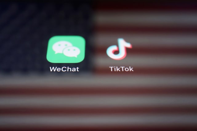 A reflection of the U.S. flag is seen on the signs of the WeChat and TikTok apps in this illustration picture taken September 19, 2020. REUTERS/Florence Lo/Illustration