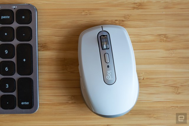 The Logitech MX Anywhere 3 mouse on a wooden table.