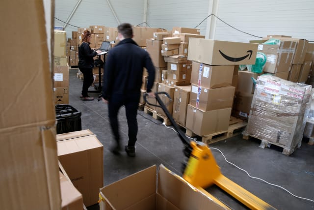 An employee prepares an order for Amazon at Porona warehouse in Bruay-sur-l'Escaut near Valenciennes, France, April 22, 2020. Picture taken, April 22, 2020.  REUTERS/Pascal Rossignol