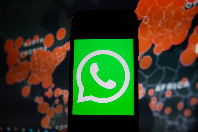 POLAND - 2020/03/19: In this photo illustration a WhatsApp logo seen displayed on a smartphone with a World map of COVID 19 epidemic on the background. (Photo Illustration by Omar Marques/SOPA Images/LightRocket via Getty Images)