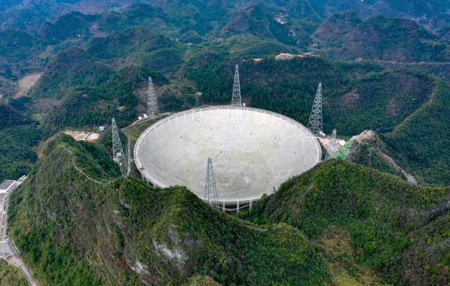 PINGTANG, Jan. 11, 2020  -- Panoramic photo taken on Jan. 11, 2020 shows China's Five-hundred-meter Aperture Spherical radio Telescope, FAST, under maintenance in southwest China's Guizhou Province. China completed commissioning of the world's largest and most sensitive radio telescope on Saturday, putting it into formal operation after a productive three-year trial.     The telescope will gradually open to astronomers around the globe, providing them with a powerful tool to uncover the mysteries surrounding the genesis and evolutions of the universe.  (Photo by Liu Xu/Xinhua via Getty) (Xinhua/Liu Xu via Getty Images)