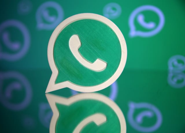 A 3D printed Whatsapp logo is seen in front of a displayed Whatsapp logo in this illustration September 14, 2017. REUTERS/Dado Ruvic