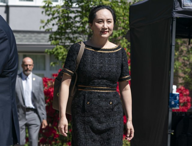 VANCOUVER, BC - MAY 27: Meng Wanzhou, CFO of Huawei, walks down her driveway to her car as she departs her home for BC Supreme Court on May 27, 2020 in Vancouver, Canada. Meng a Huawei executive is fighting extradition to the United States and has been under house arrest in Vancouver for almost a year and a half. (Photo by RichLam/Getty Images)
